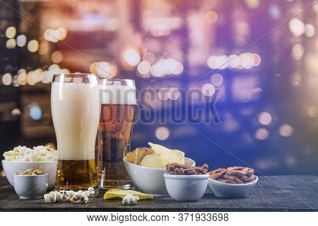 International Beer Day. Glasses With Light Beer And Salty Snacks On A Bar Counter