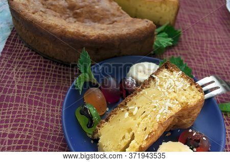 Pie On A Tablecloth Burgundy Color. A Piece Of Pie With Jelly Candies, Banana Slices And Coconut Fla