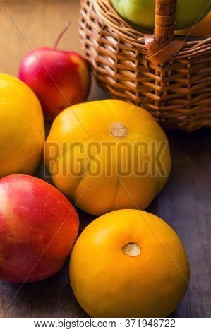 Still Life Of Yellow Melons And Red Apples On A Wooden Background. Close Up. Ripe, Bright Fruits, A 