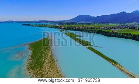 Aerial View Over Lake Forggensee At The City Of Fuessen In Bavaria Germany