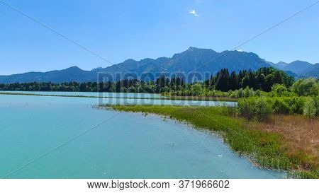 Aerial View Over Lake Forggensee At The City Of Fuessen In Bavaria Germany