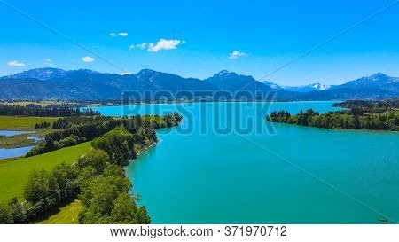 Aerial View Over Lake Forggensee At The City Of Fuessen In Bavaria Germany