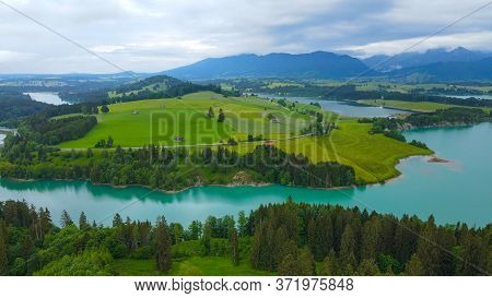 Aerial View Over Lake Forggensee At The City Of Fuessen In Bavaria Germany