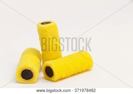 Three Licorice Pieces In Yellow And Black, Almost Look Like Fingers Making One An Indecent Gesture