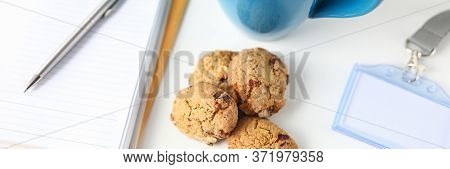Close-up Of Worker Having Coffee Break In Office. Blue Cup, Cookies, Datebook With Notes, Computer K