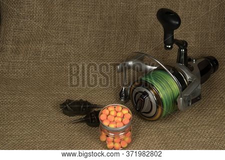 Fishing, Carp Reel With Fishing Linel On The Background Of Burlap . Burlap