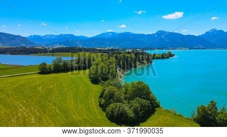 Aerial View Over Lake Forggensee At The City Of Fuessen In Bavaria Germany