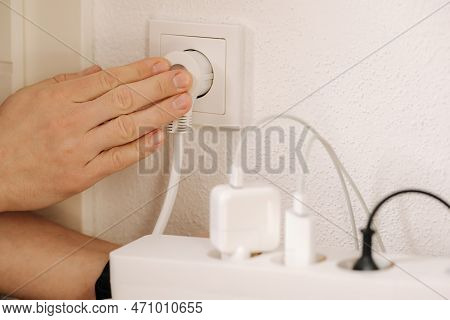 The Extension Cord Filled With Chargers Is Connected To A 220v Outlet
