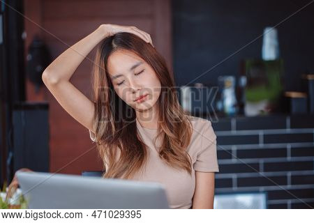 Asian Woman Having Neckache During Working With Laptop Computer In Office, Business Woman Work Hard 