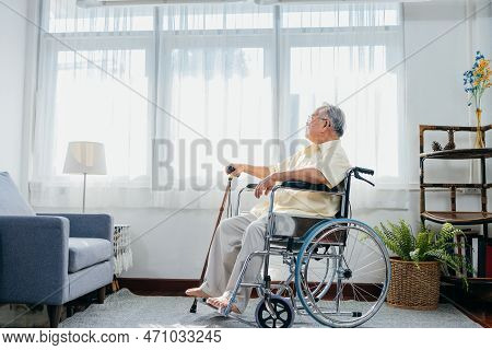 Asian Senior Old Man Sitting On Wheelchair Walking With Walker Cane Stick In Nursing Home, Elderly M