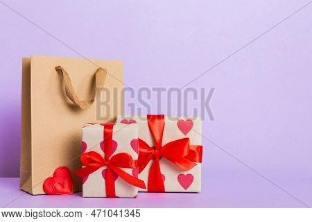 Shopping Bag With Gift Box On Colored Background Perspecrive View. Space For Text Holiday Concept.