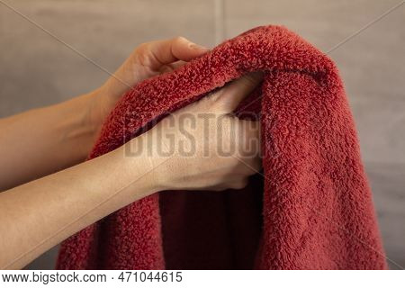 Woman Drying Her Hands With A Towel In The Bathroom