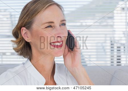 女商人在明亮的办公室打电话和看别处的肖像