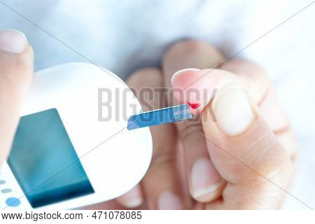 Hand Of People Check Diabetes And High Blood Glucose Monitor With Digital Pressure Gauge. Healthcare