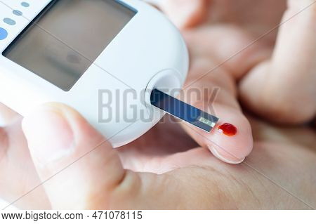Hand Of People Check Diabetes And High Blood Glucose Monitor With Digital Pressure Gauge. Healthcare