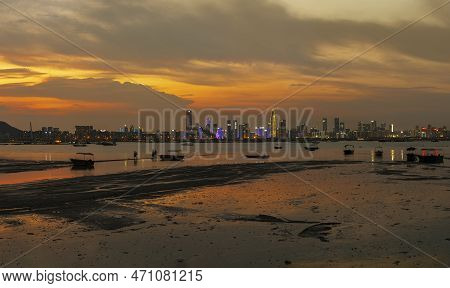 Idyllic Landscape Of Lau Fau Shan In Hong Kong And Skyline Of Shenzhen City In China Under Sunset