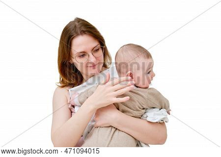 A Mother Woman Holds An Infant Baby To Regurgitate Excess Air After Breastfeeding, Isolated On A Whi