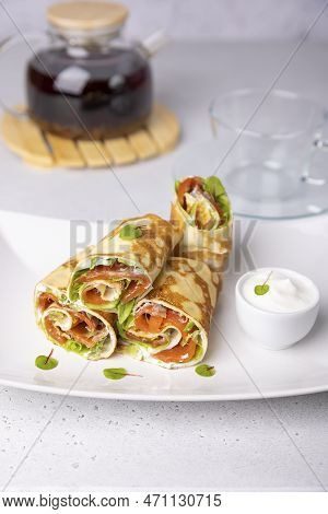 Pancakes With Salmon (trout), Sour Cream, Greenstuff And Tea. Thin, Not Sweet Blinchiki Stuffed With