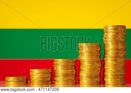 Coins Forming Upgoing Graph Near Flag Of Lithuania. Economic And Financial Growth Of Lithuania