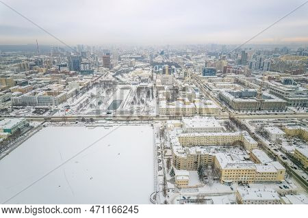 Embankment Of Central Pond And Plotinka In Yekaterinburg At Winter Sunset. Winter Snow-covered City.