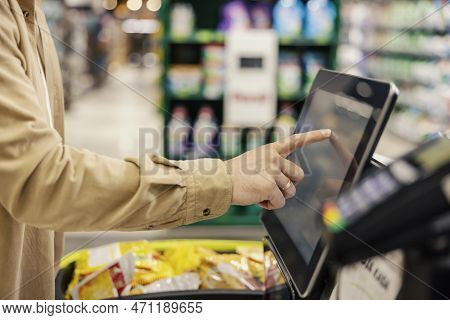 Hand Of A Man At Self-service Checkout In Supermarket.