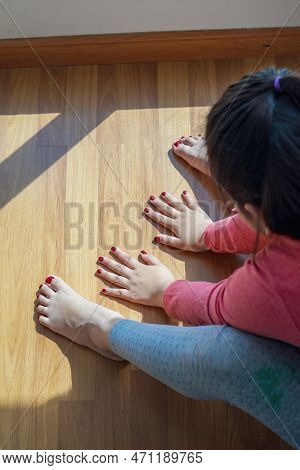 Hands And Feet With Henna In A Bright Sunlight On The Floor. Drying Henna At Home.