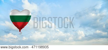 Flag Of Bulgary On Heart-shaped Balloon Against Sky Clouds Background. Education, Charity, Emigratio