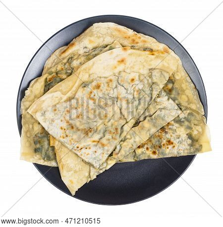 Tatar Cuisine - Above View Of Yantik With Herbs And Cheese (stuffed Grilled Turnover) On Black Plate