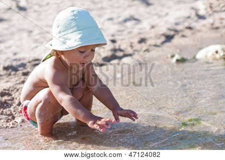 Cute Baby Playing On The Beach