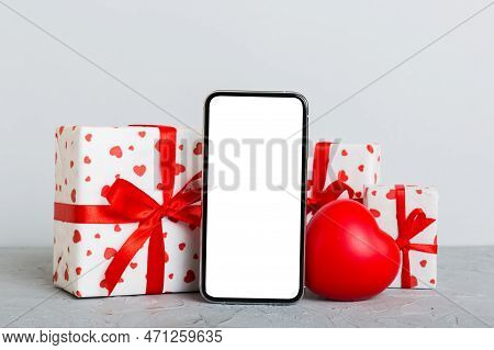 Mobile Phone With Blank Screen On Colored Background With Hearts, Calendar And Gift Box, Valentine D