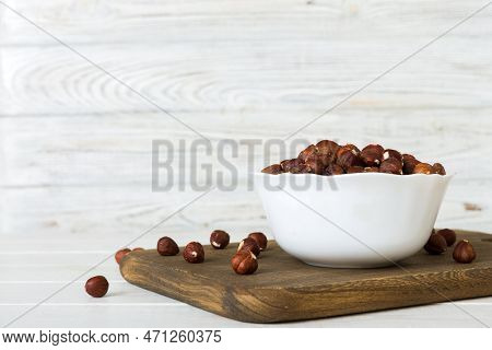 Wooden Bowl Full Of Hazelnuts On Table Background. Healthy Eating Concept. Super Foods.