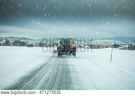 Winter Service Truck Or Gritter Spreading Salt On The Road Surface To Prevent Icing In Stormy Snow W