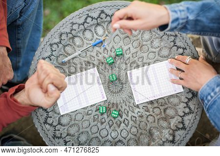 Two Friends, Men And Women Are Playing Yamb Game In Their Free Time In The  Spring Garden
