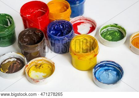 Bonks With Watercolor Paint. Watercolor Paints Of Different Colors On A White Background. Jars With