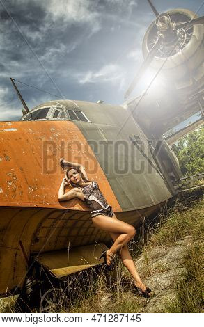 Portrait Of A Beautiful Young Girl In Sexy  Lingerie  Near The Old Abandoned Broken Plane. Concept Y
