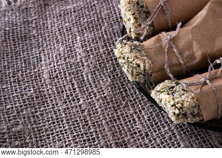 Kozinak From Hemp Seeds In A Paper Wrapper On A Fabric Background And Copyspace