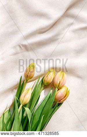Colorful Tulips On Linen Fabric. Yellow Tulips On Wrinkled Coton Of Champagne Color. Muted Tone. Spr