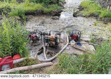 Water Pumps Pump Water From The Pond. Drainage Of A Reservoir, Swamp, Lake With The Help Of High Pre