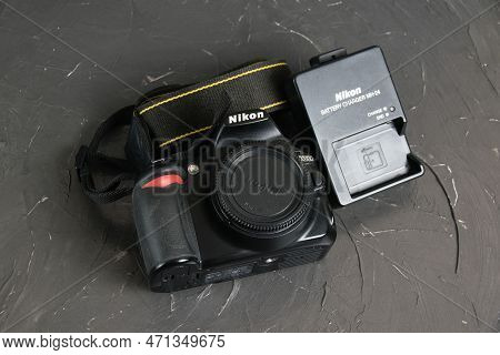 Ukraine, Chernihiv, February 21, 2023: Old Used Photo Equipment, Old Nikon Camera And Charger On A G