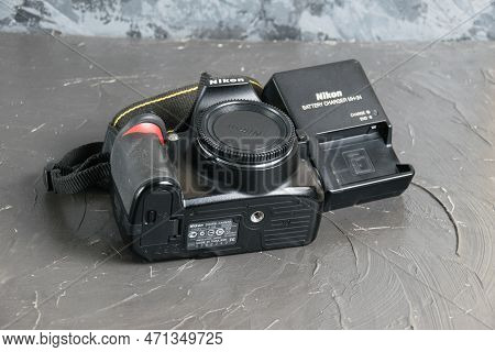 Ukraine, Chernihiv, February 21, 2023: Old Used Photo Equipment, Old Nikon Camera And Charger On A G
