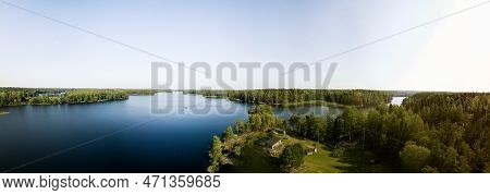 Panoramic View Over Forest Lake With A Lakeside Cabin A Clear Summer Day In Sweden