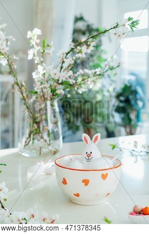 Funny Easter Eggs Containers With Bunny Ears Filled With Candy And Chocolate In Bowl On White Kitche