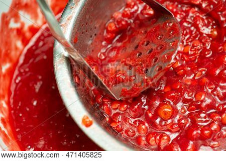 Making Jam From Guelder Rose Berries. Squeezing Guelder Rose Berries For Jam