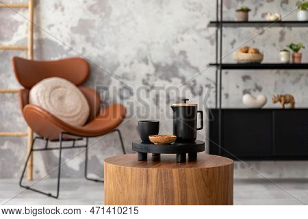 The Stylish Composition Of Wabi Sabi Interior With Coffee Table, Black Accessories, Armchair And Rac