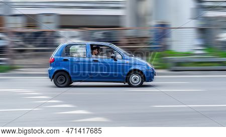 Two Guys Are Driving A Small Blue Daewoo Matiz Car Down The Street. Moscow, Russia - August 2021
