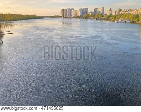 Beautiful Panoramic View Of The City Of Kyiv Dneper River At Sunset On Dark Blue Water With Glowing 