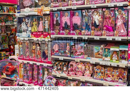 Shelves With Dolls For Children In A Toy Store. Large Selection Of Dolls From Different Manufacturer