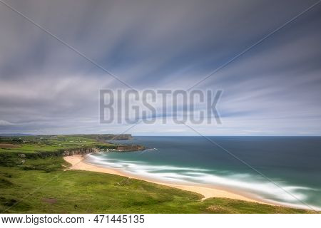 Whitepark Bay Beach And Portbradden Harbour With Cliffs, Sandy Beach, Blurred Water And Sky On Long 
