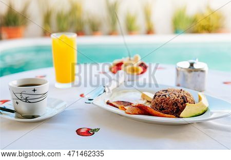 Morning Breakfast On The Table Near A Swimming Pool. Close-up Of A Traditional Breakfast On A Table