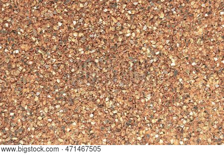 Abstract Blurred Background Of Small Pebbles In Orange And Brown